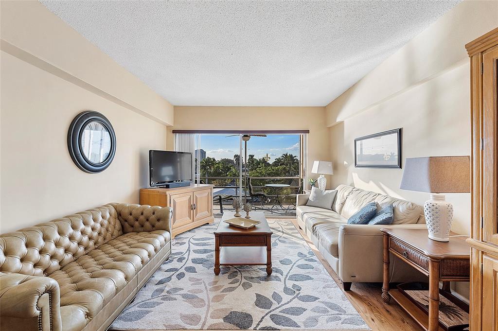 1481 South Ocean Boulevard, Unit 416A Lauderdale-by-the-Sea, FL 33062 - Photo 4 of 16 a living room with furniture and a large window