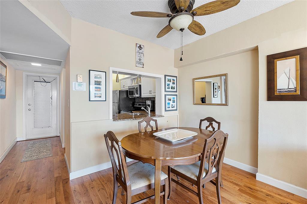 1481 South Ocean Boulevard, Unit 416A Lauderdale-by-the-Sea, FL 33062 - Photo 8 of 16 a dining room with furniture a chandelier and wooden floor