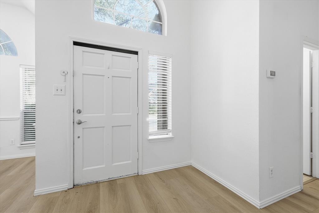 5023 Falcon Hollow Road McKinney, TX 75072 - Photo 5 of 25 Entrance foyer featuring light wood finished floors and a high ceiling