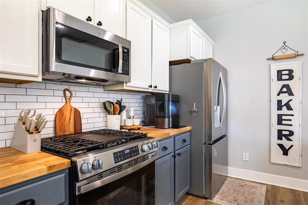 416 Allbright Road Celina, TX 75009 - Photo 13 of 40 a kitchen with stainless steel appliances granite countertop a stove and a refrigerator