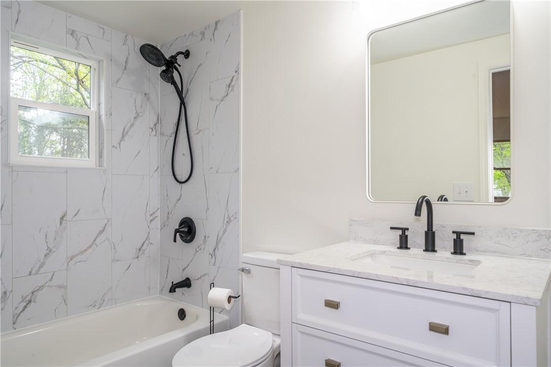 11296 Pansing Road Brookville, OH 45309 - Photo 21 of 53 This bright bathroom features a vanity with sleek fixtures and a tiled bath for daily rejuvenation.