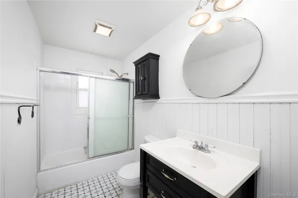 a bathroom with a sink a shower and a mirror