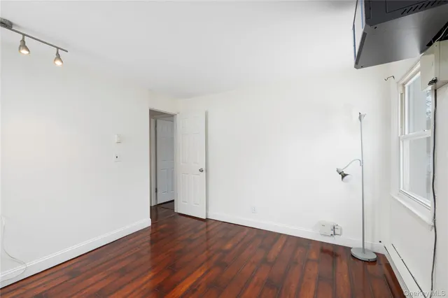 a view of a room with wooden floor