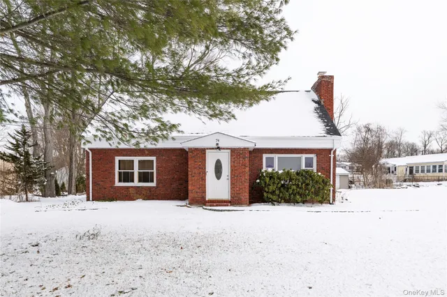 a front view of a house with a yard covered in snow