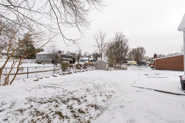 an aerial view of residential house with outdoor space and trees around