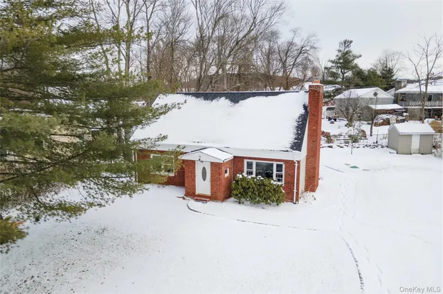a view of a house with a yard covered in snow
