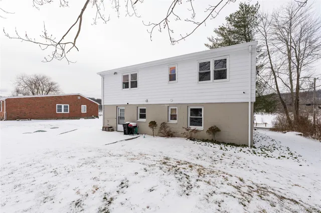 a view of a house with a snow in the yard