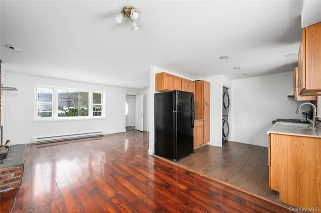 a view of a kitchen with wooden floor and a refrigerator