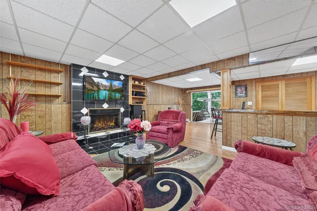 a living room with furniture a flat screen tv and a fireplace