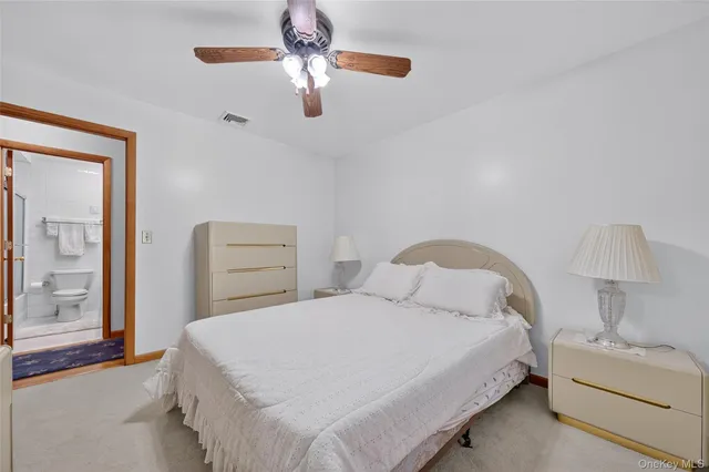 a bedroom with a bed and a lamp