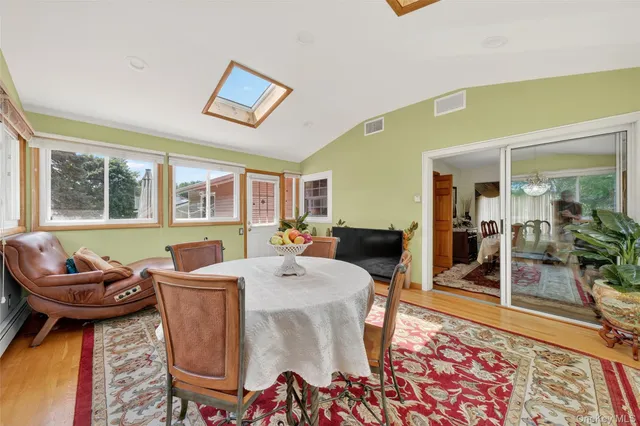 a living room with furniture a flat screen tv and a floor to ceiling window