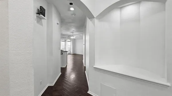 a view of a hallway with wooden floor
