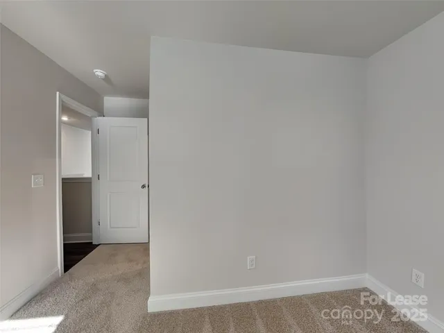 a view of hallway with a rug