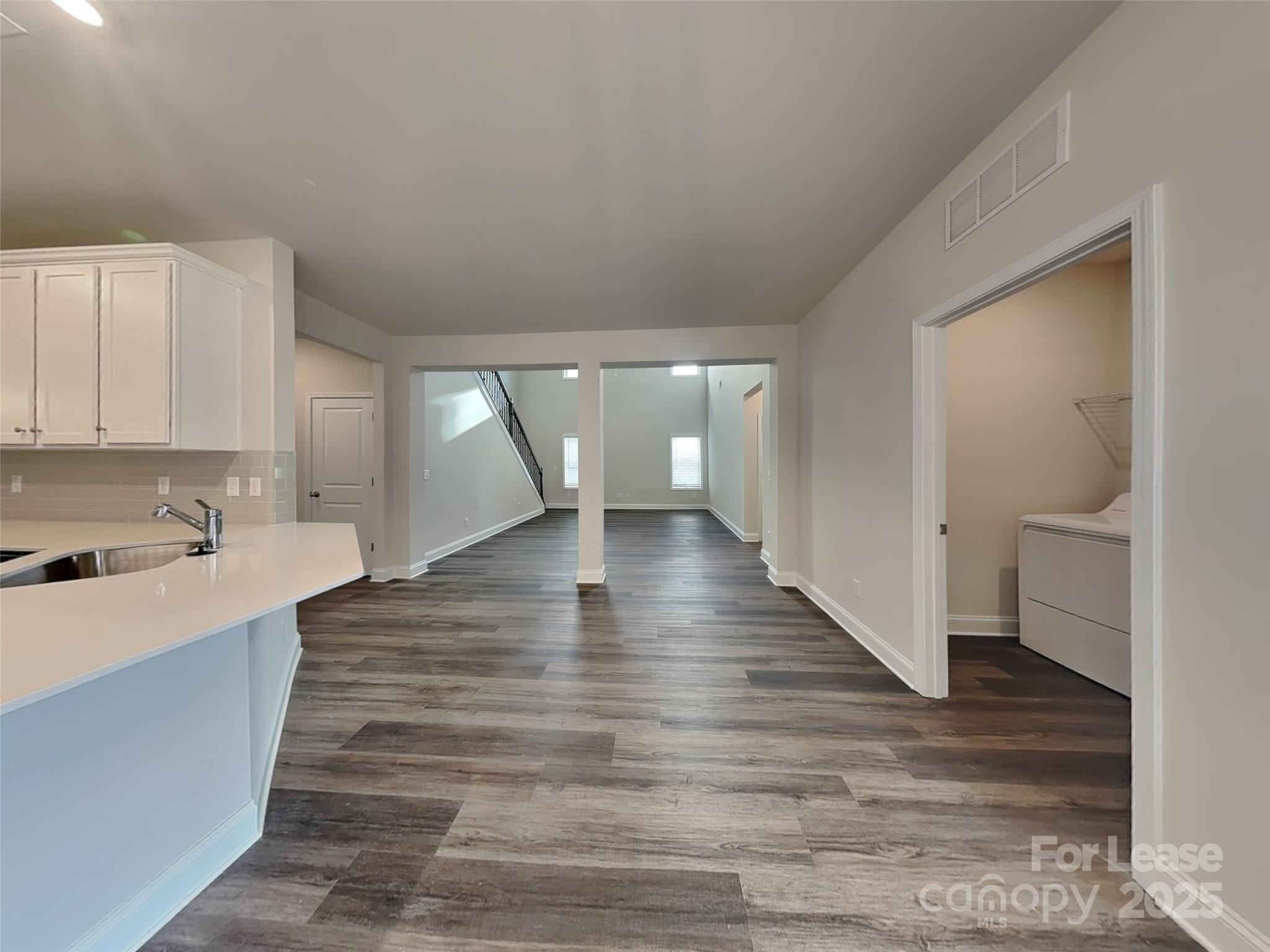 168 Queenshall Road Mooresville, NC 28117 - Photo 4 of 18 a view of a kitchen with wooden floor and a sink
