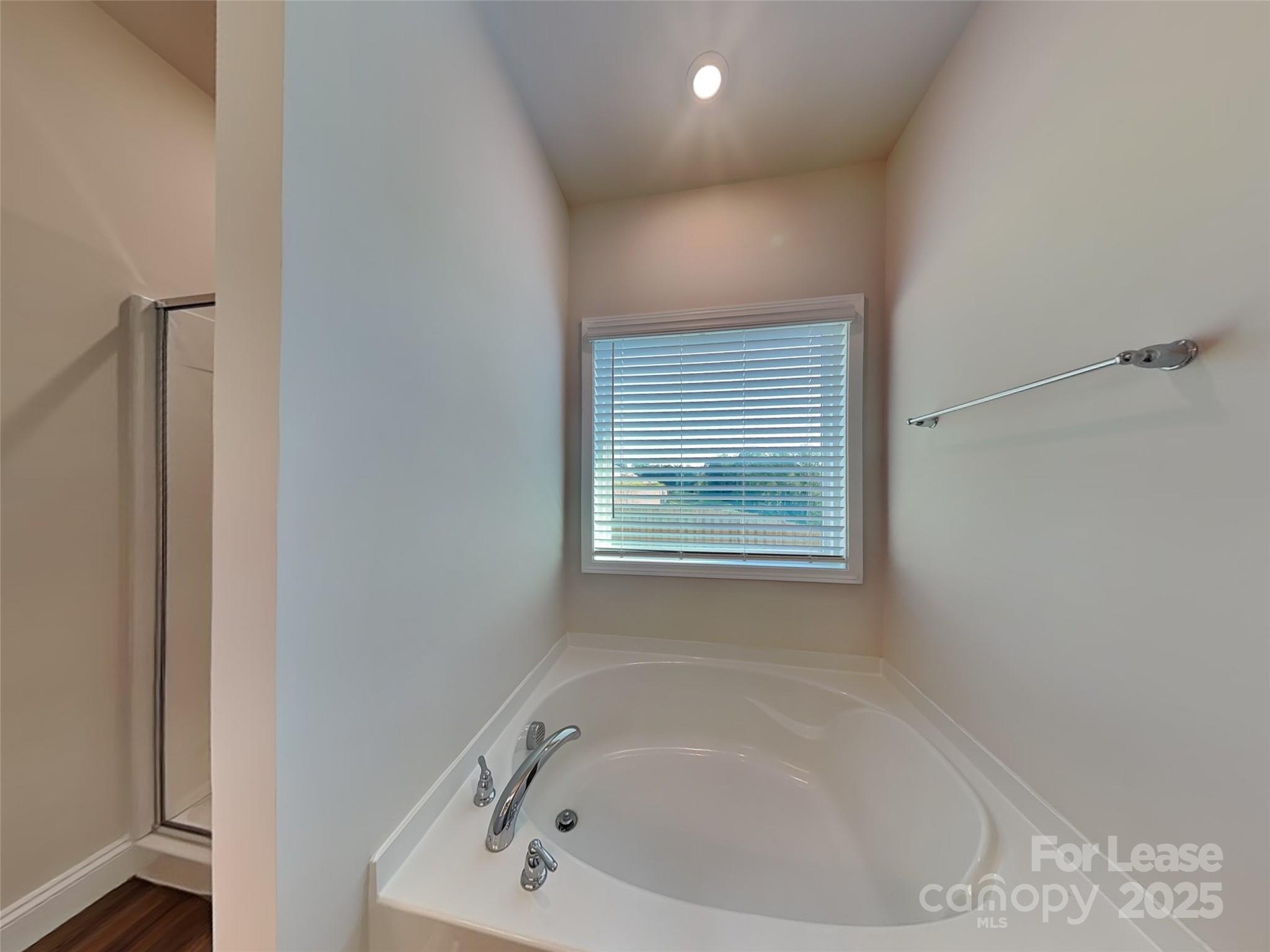 168 Queenshall Road Mooresville, NC 28117 - Photo 6 of 18 a white bath tub sitting in a bathroom