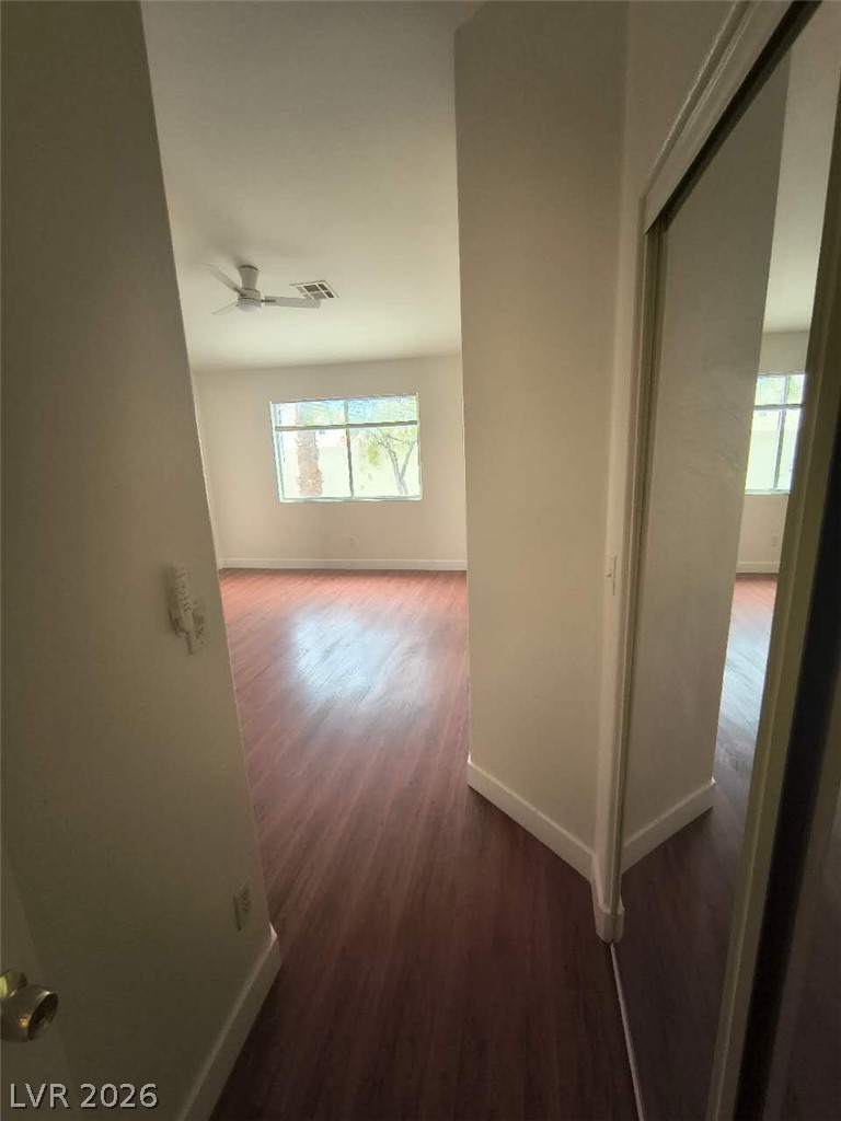 9725 Pima Point Avenue Las Vegas, NV 89147 - Photo 14 of 35 Rich hardwood-style flooring extends through this airy room, illuminated by natural light.
