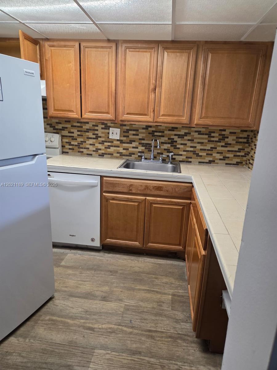 8060 North Colony Circle, Unit 103 Tamarac, FL 33321 - Photo 2 of 8 a view of kitchen cabinets and wooden floor
