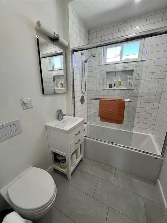 48 Sheffield Road, Unit 2 Boston, MA 02131 - Photo 11 of 18 a bathroom with a toilet sink and mirror