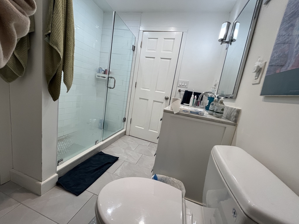 48 Sheffield Road, Unit 2 Boston, MA 02131 - Photo 16 of 18 a bathroom with a sink a toilet a mirror and shower