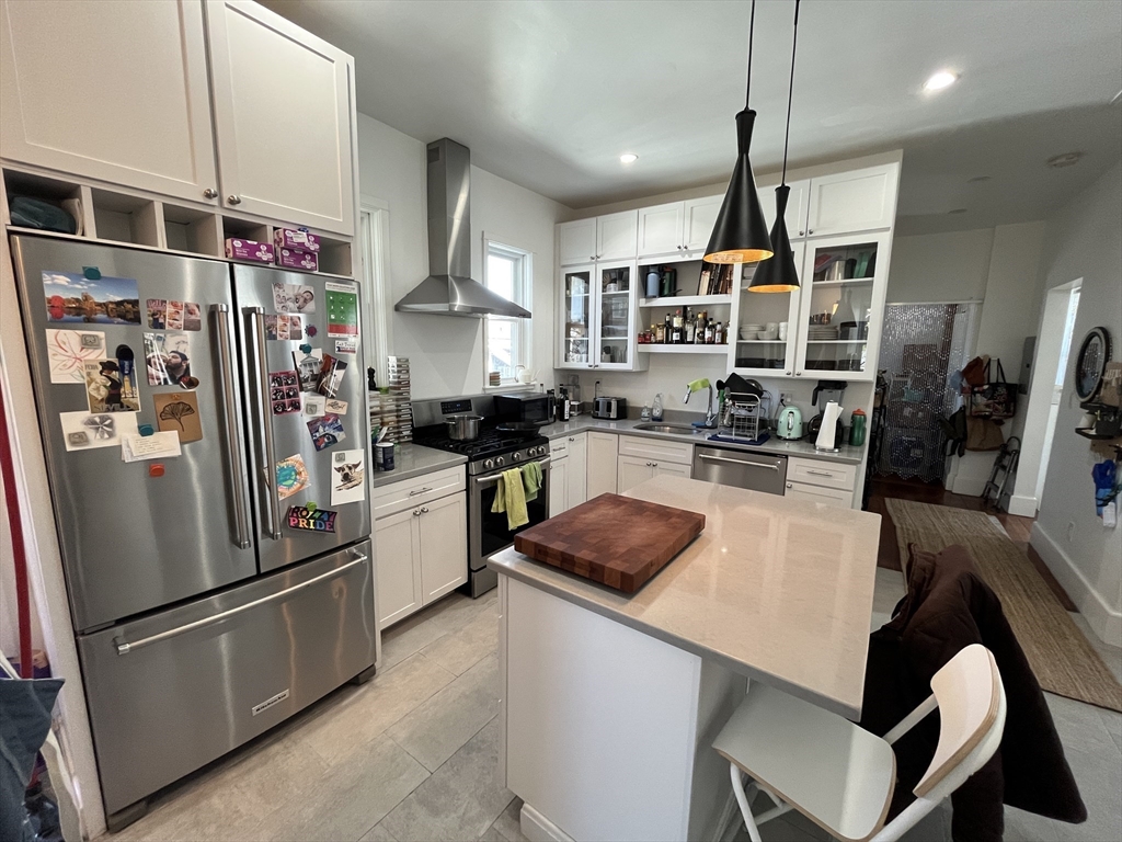 48 Sheffield Road, Unit 2 Boston, MA 02131 - Photo 3 of 18 a kitchen with stainless steel appliances granite countertop a refrigerator a sink dishwasher a stove and white cabinets with wooden floor