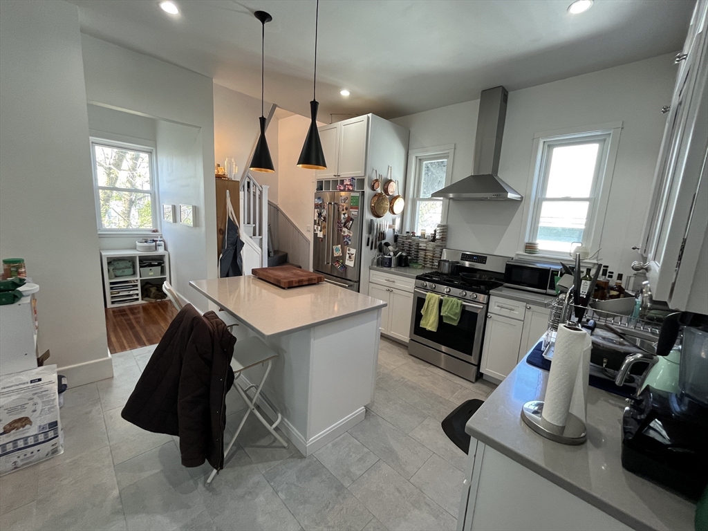48 Sheffield Road, Unit 2 Boston, MA 02131 - Photo 4 of 18 a kitchen with stainless steel appliances granite countertop a sink a stove and a wooden floors