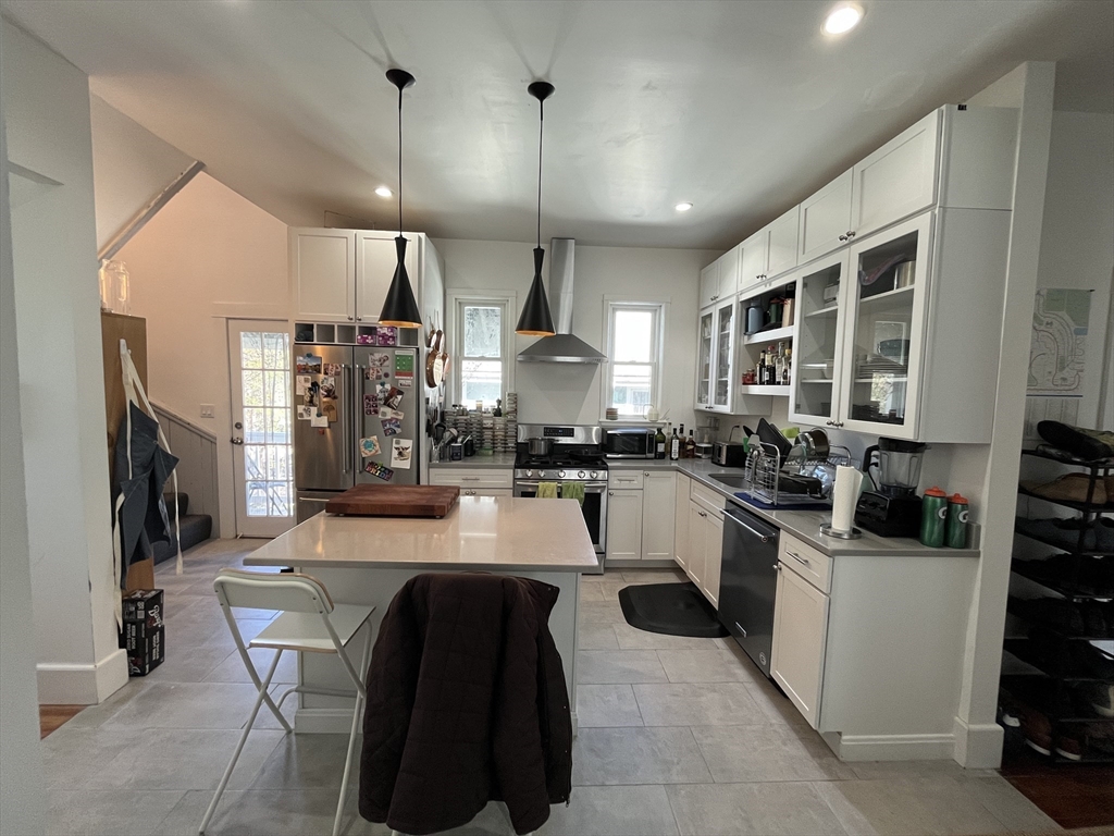 48 Sheffield Road, Unit 2 Boston, MA 02131 - Photo 5 of 18 a kitchen with a sink a counter top space stainless steel appliances and a window