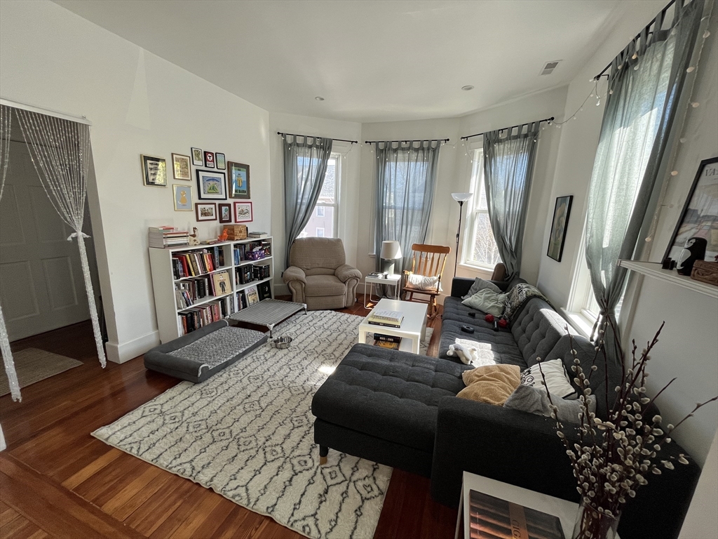 48 Sheffield Road, Unit 2 Boston, MA 02131 - Photo 7 of 18 a living room with furniture bookshelf and a large window