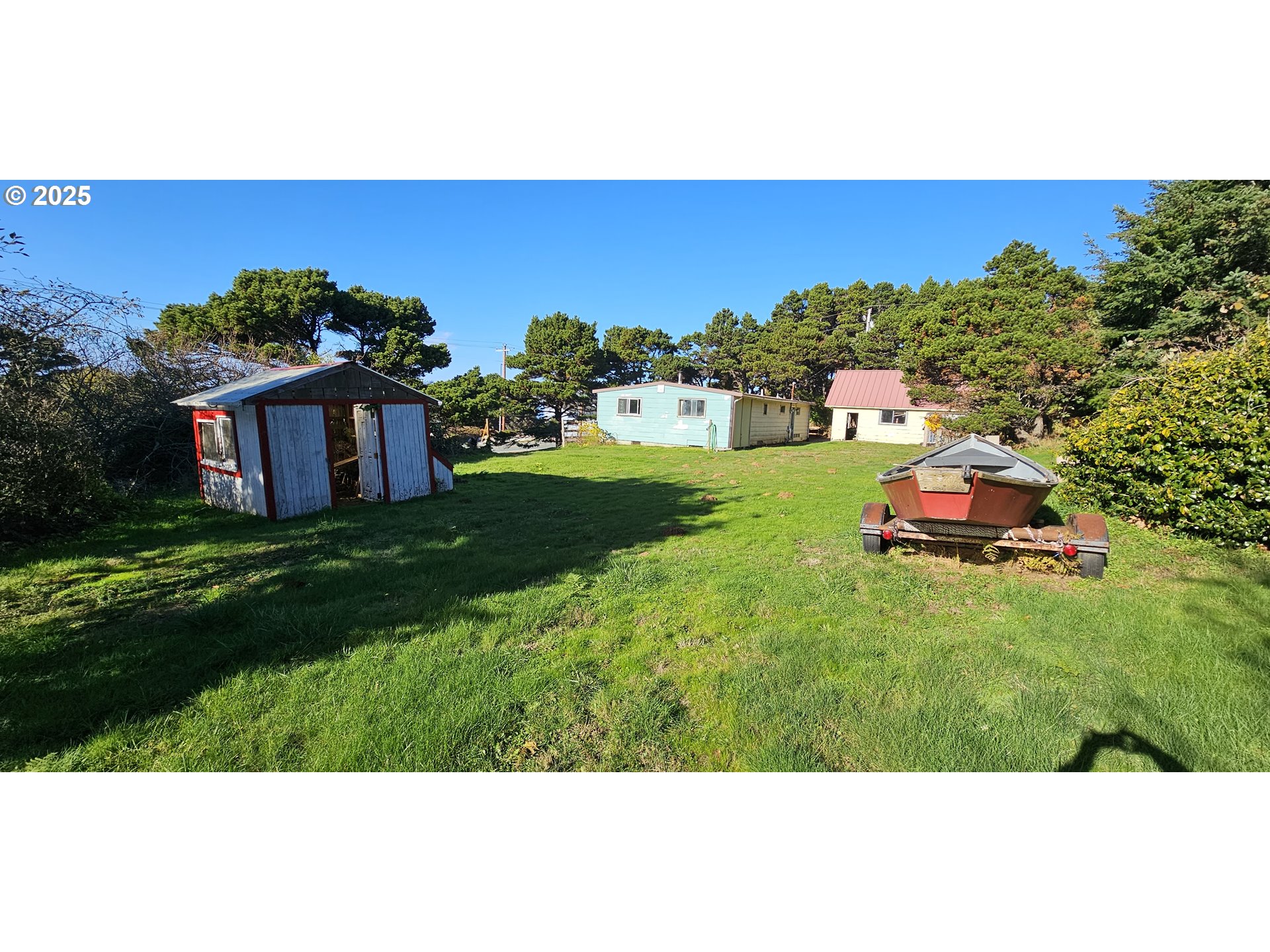 33261 Ophir Road Gold Beach, OR 97444 - Photo 4 of 36 a backyard of a house with lots of green space