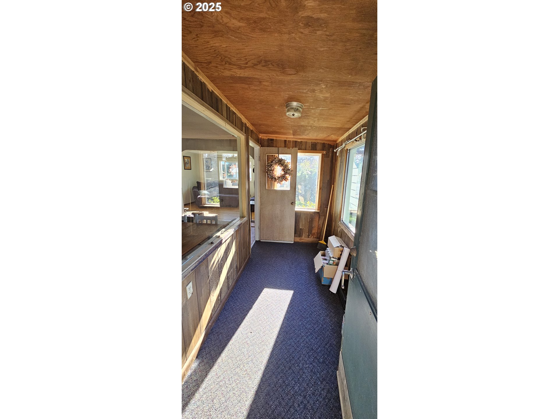 33261 Ophir Road Gold Beach, OR 97444 - Photo 5 of 36 a view of a hallway with furniture and a bathroom