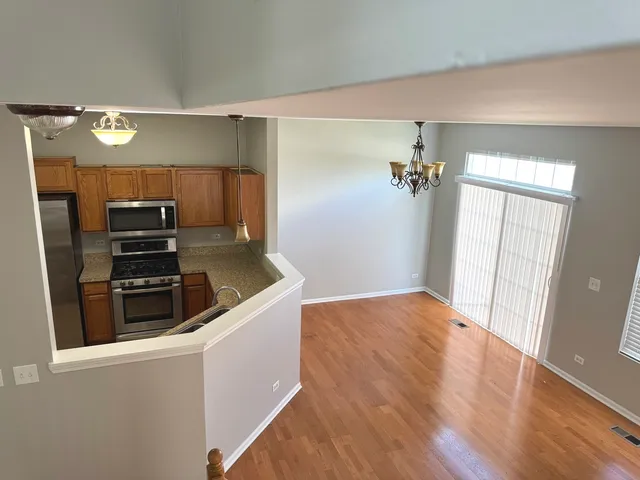 a kitchen with granite countertop a sink and stainless steel appliances