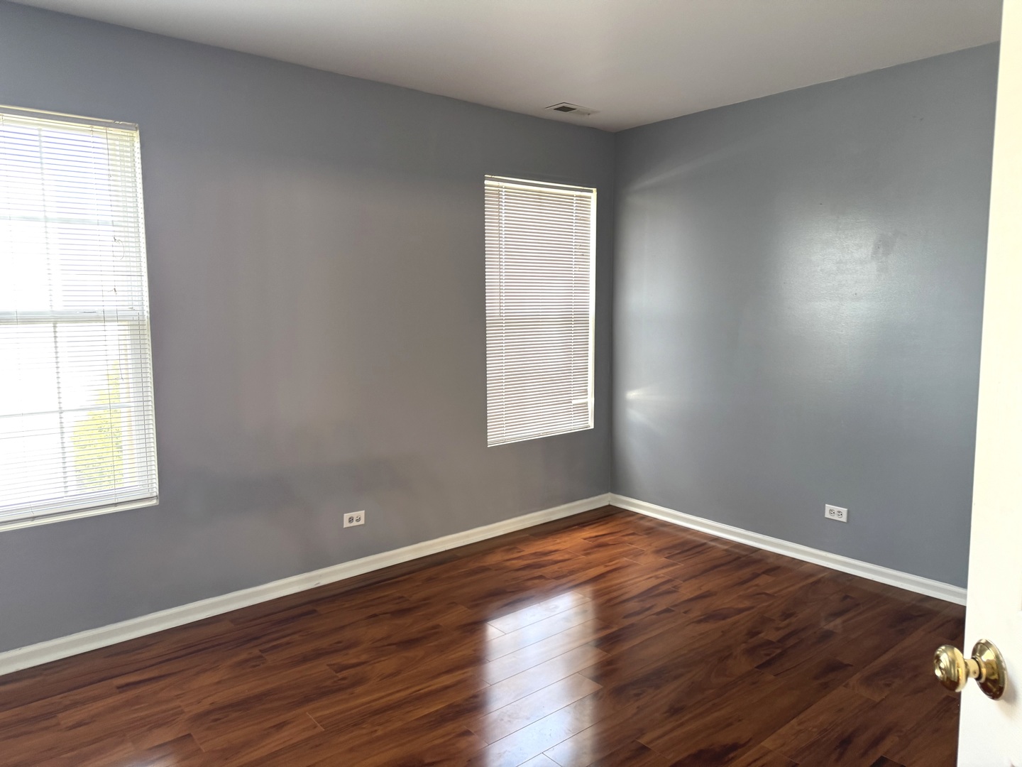 537 North Red Deer Road Round Lake, IL 60073 - Photo 9 of 12 an empty room with wooden floor and windows
