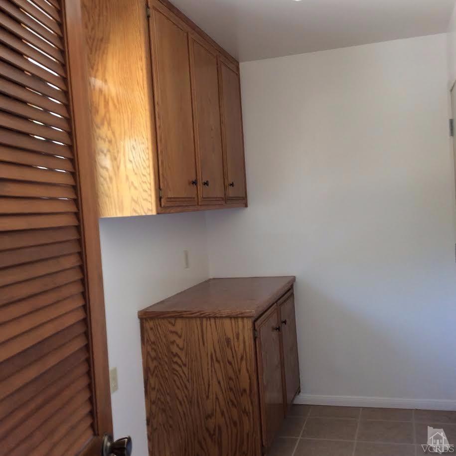 22813 Clover Spring Place Tehachapi, CA 93561 - Photo 13 of 20 a utility room with wooden floor washer and dryer