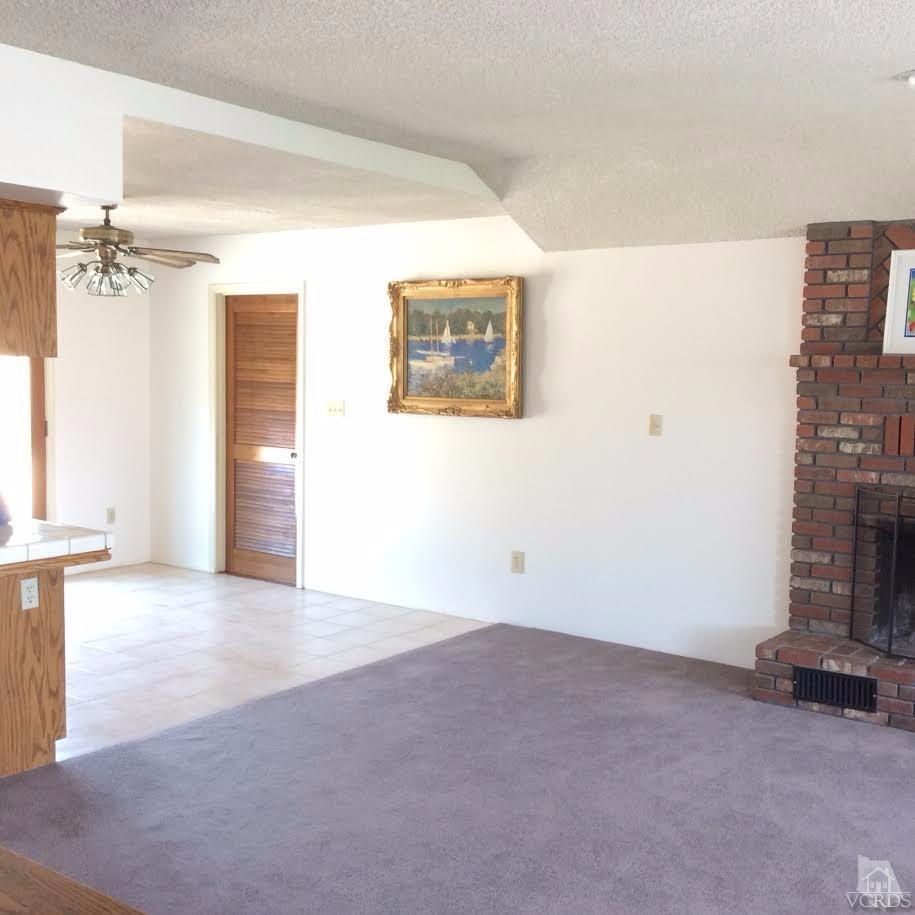 22813 Clover Spring Place Tehachapi, CA 93561 - Photo 3 of 20 a view of an empty room with a fireplace