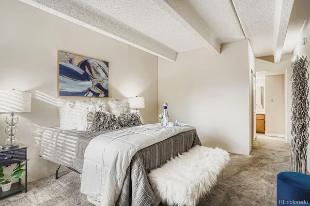 a bedroom with a bed and a painting on the wall