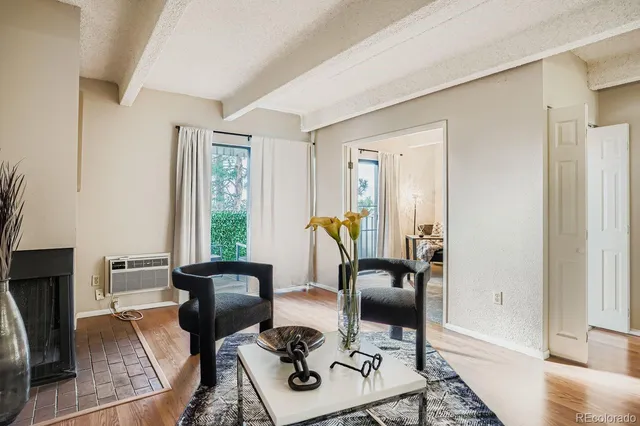 a living room with furniture fireplace and a window