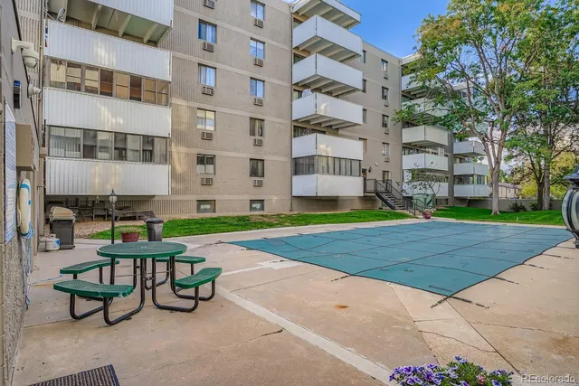 a view of a building with garden and sitting area