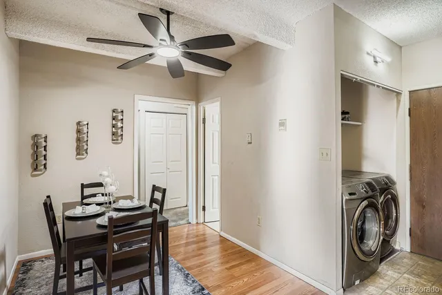 a view of a dining room with furniture a chandelier and a window