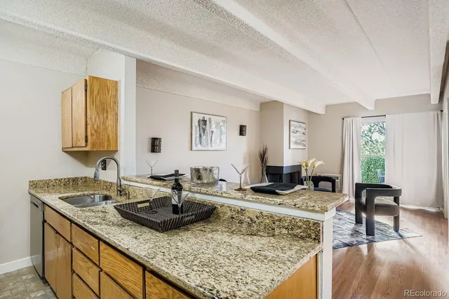 a living room with kitchen island granite countertop furniture and rug