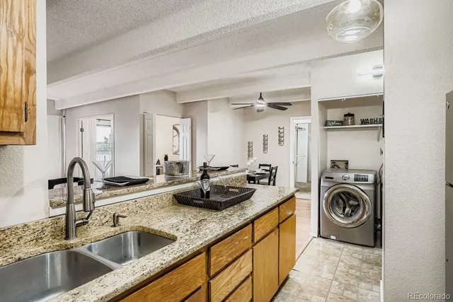 a utility room with sink dryer and washer