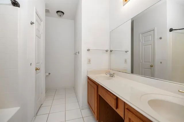 a bathroom with a tub sink and mirror