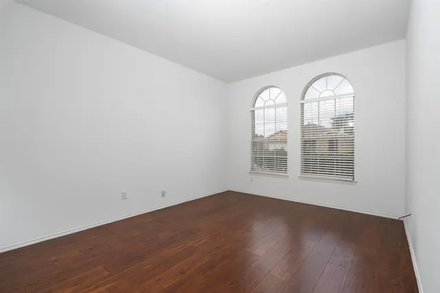 a view of a room with wooden floors and window