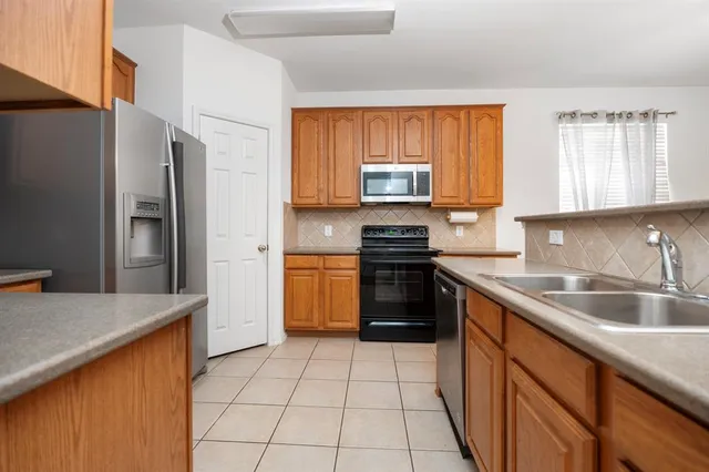 a kitchen with stainless steel appliances a sink cabinets and a counter top space