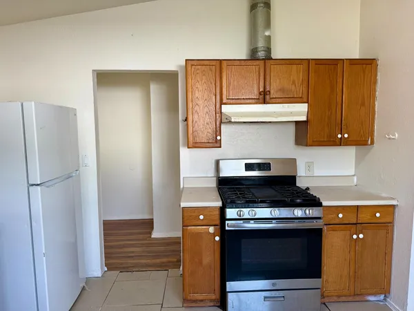 a kitchen with stainless steel appliances a stove and a refrigerator