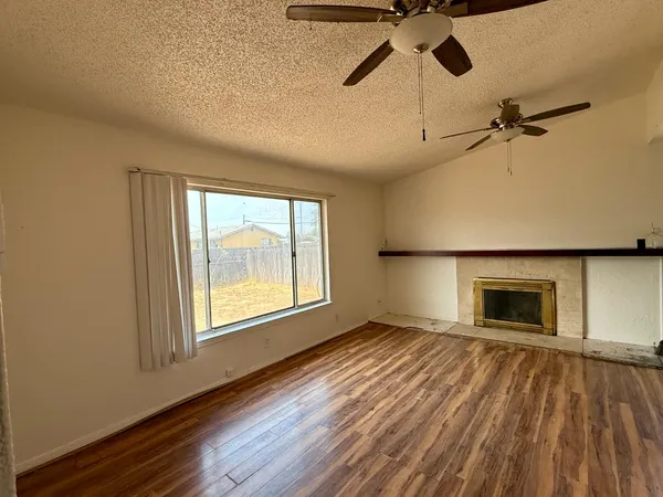 wooden floor chandelier and windows in a room