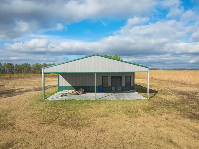 a view of a house next to a yard