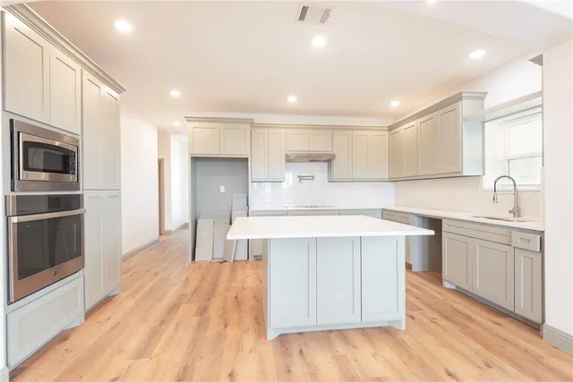 a view of empty room with a fireplace and wooden floor