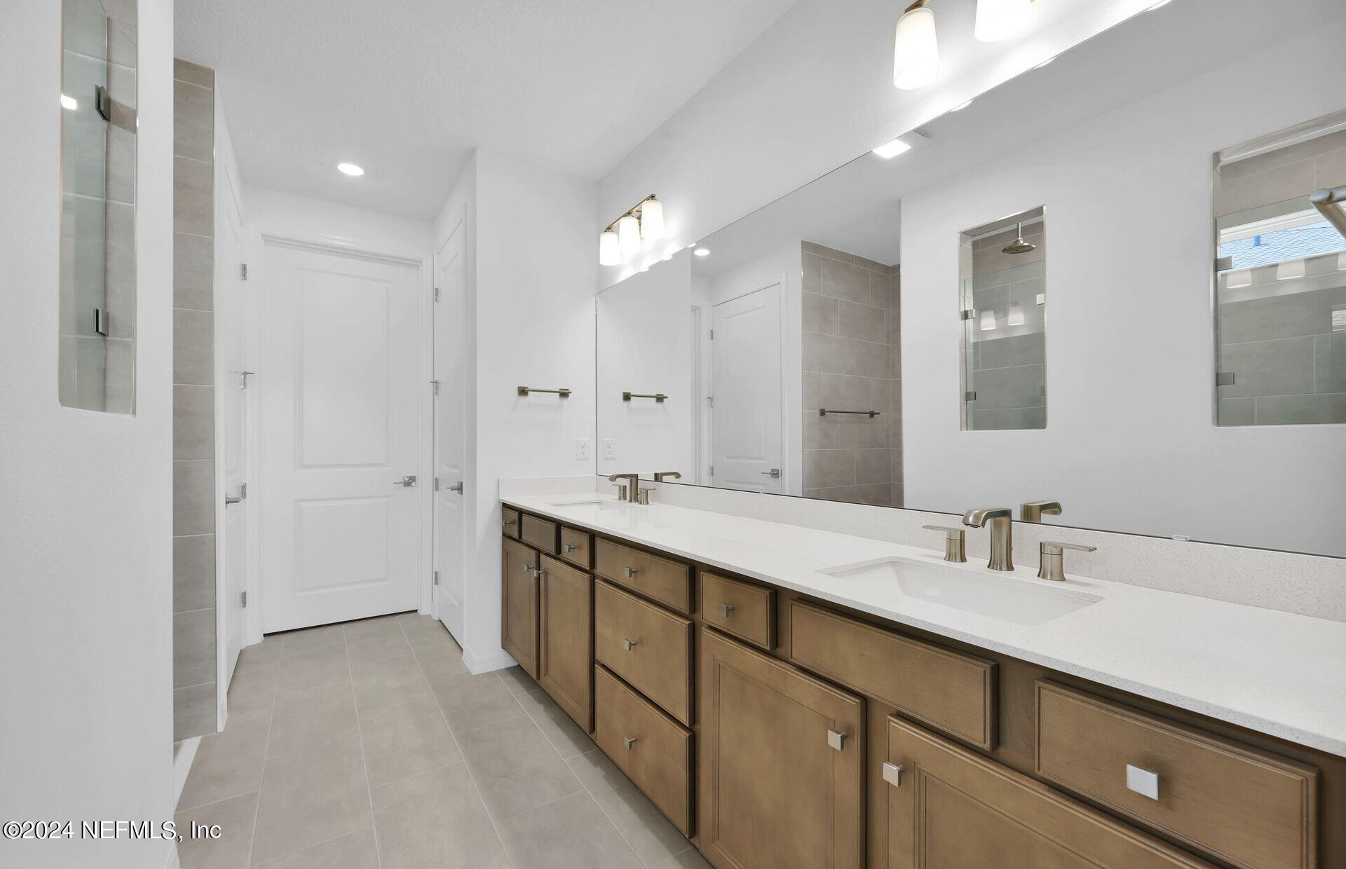 236 Hickory Pine Drive St. Augustine, FL 32092 - Photo 22 of 46 a bathroom with a double vanity sink and a mirror