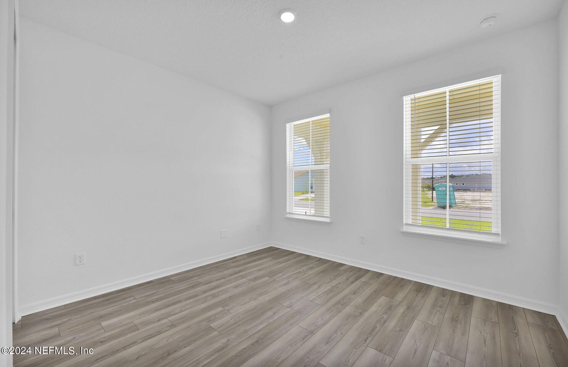 236 Hickory Pine Drive St. Augustine, FL 32092 - Photo 25 of 46 an empty room with wooden floor and windows