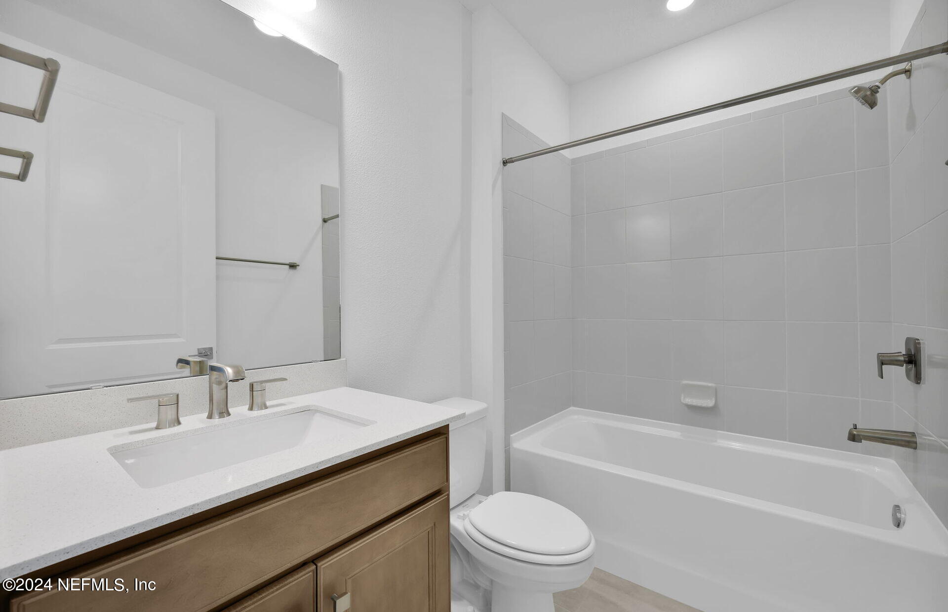 236 Hickory Pine Drive St. Augustine, FL 32092 - Photo 26 of 46 a bathroom with a granite countertop sink a toilet and shower