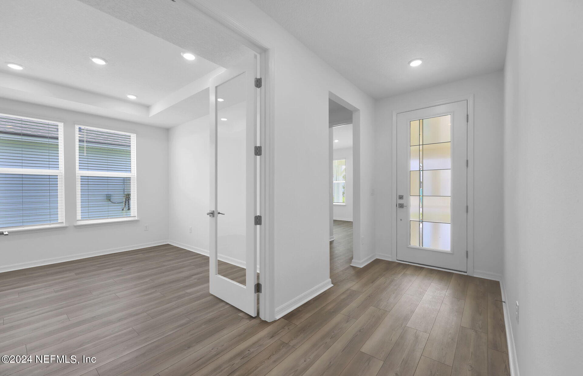 236 Hickory Pine Drive St. Augustine, FL 32092 - Photo 4 of 46 an empty room with wooden floor and windows